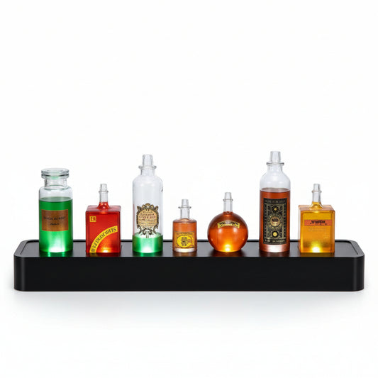 A set of six decorative potion bottles with glowing internal lights, arranged on a black display tray on a wooden table with a dark, book-filled background.